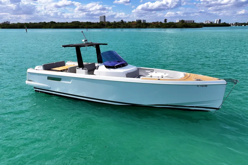  Yacht Photos Pics 2018 Fjord 36 Xpress boat on turquoise water under a partly cloudy sky.