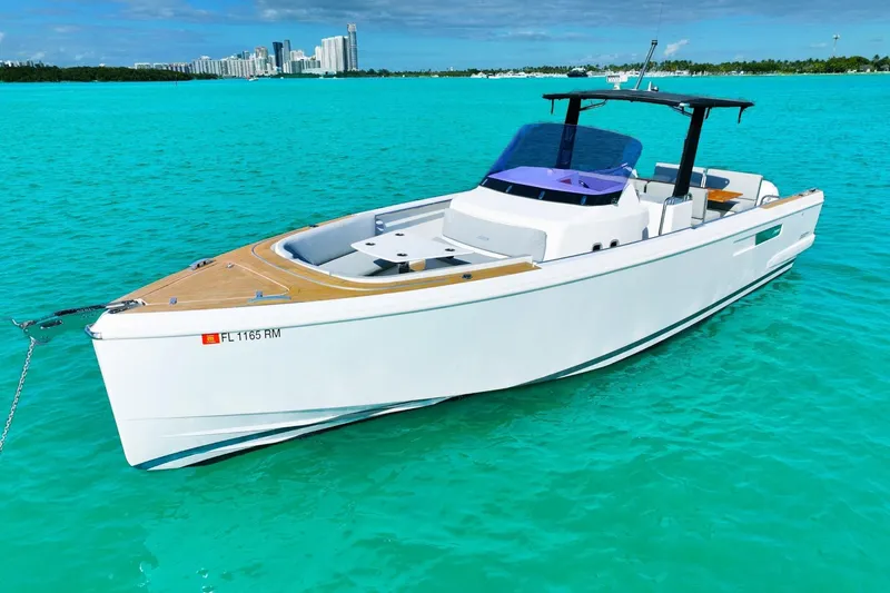  Yacht Photos Pics 2018 Fjord 36 Xpress boat on turquoise water with city skyline in background.