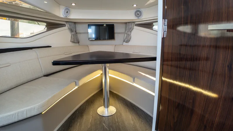 At Times Yacht Photos Pics Interior of 2019 Sea Ray Sundancer 320 yacht with elegant seating and modern table.