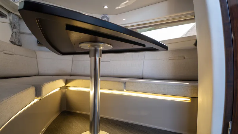 At Times Yacht Photos Pics Interior of 2019 Sea Ray Sundancer 320, featuring a modern seating area with ambient lighting.