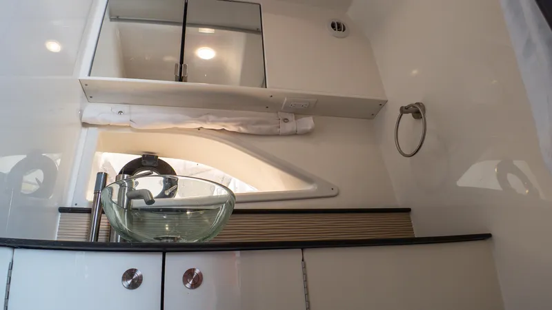 At Times Yacht Photos Pics 2019 Sea Ray Sundancer 320 bathroom with glass sink and modern fixtures.