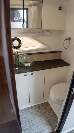 At Times Yacht Photos Pics 2019 Sea Ray Sundancer 320 bathroom with modern sink, toilet, and storage cabinets.