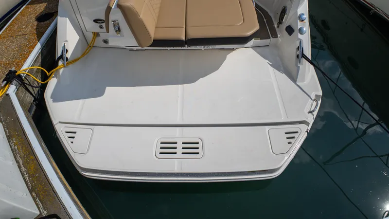 At Times Yacht Photos Pics 2019 Sea Ray Sundancer 320 swim platform with tan seating, docked at marina.