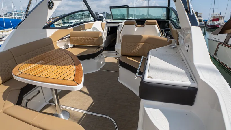 At Times Yacht Photos Pics 2019 Sea Ray Sundancer 320 interior with elegant seating and wooden table.