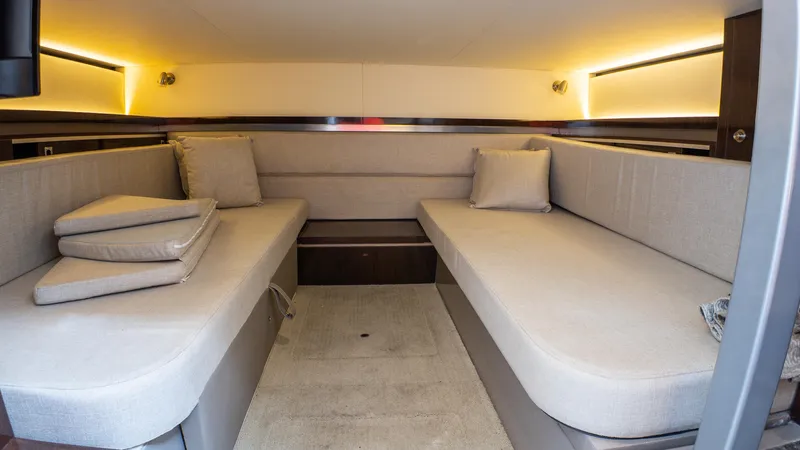 At Times Yacht Photos Pics Interior of 2019 Sea Ray Sundancer 320, featuring cozy seating and ambient lighting.