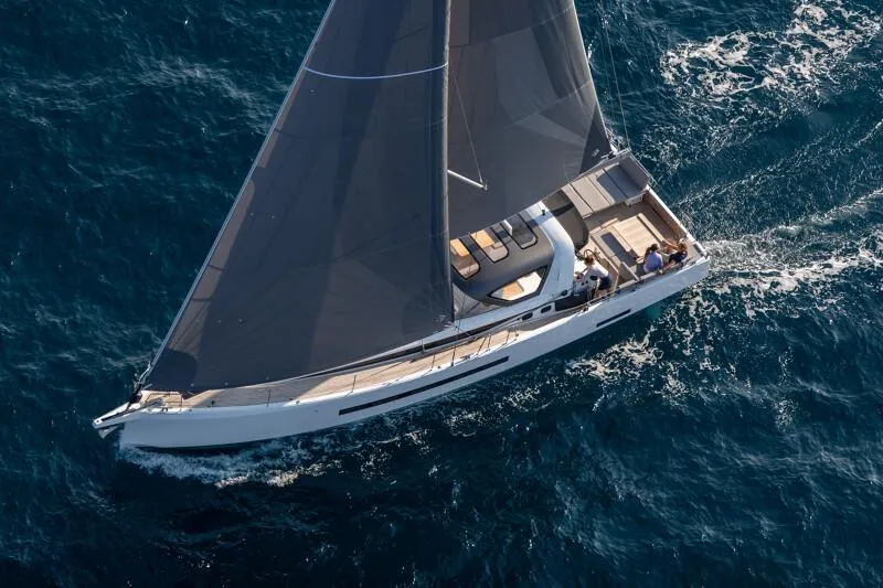  Yacht Photos Pics 2025 Jeanneau Yachts 55 sailing on open sea, aerial view.