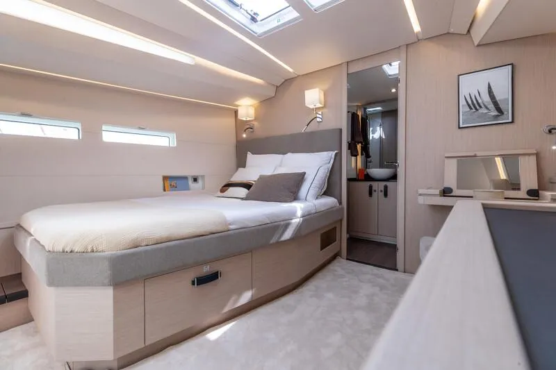  Yacht Photos Pics Luxurious interior of 2025 Jeanneau Yachts 55, featuring a cozy bedroom and modern design.