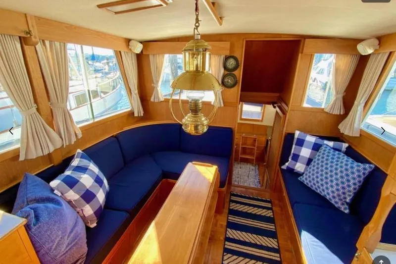 Yonder Yacht Photos Pics Interior of 1984 Grand Banks 36 Classic yacht with blue seating and nautical decor.
