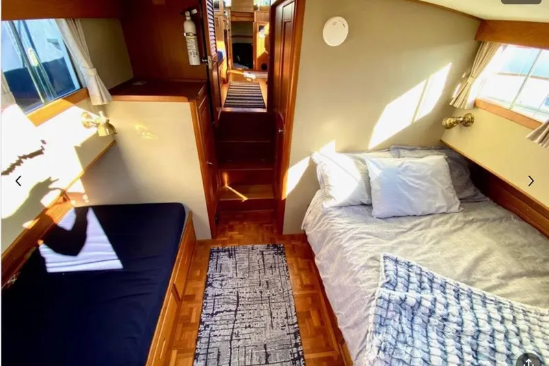 Yonder Yacht Photos Pics Cozy cabin interior of 1984 Grand Banks 36 Classic yacht with beds and wooden decor.
