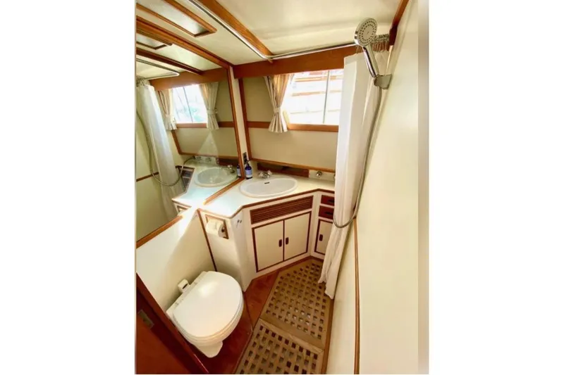Yonder Yacht Photos Pics 1984 Grand Banks 36 Classic yacht bathroom with shower, sink, and toilet.
