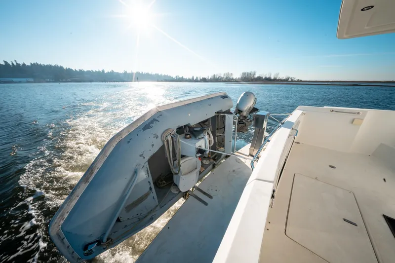  Yacht Photos Pics 2003 Navigator 3900 boat cruising on a sunny day with a small dinghy attached.