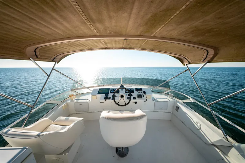  Yacht Photos Pics 2003 Navigator 3900 yacht helm with ocean view under canopy.