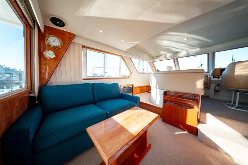  Yacht Photos Pics Luxurious interior of 2003 Navigator 3900 yacht with blue sofa and wooden accents.