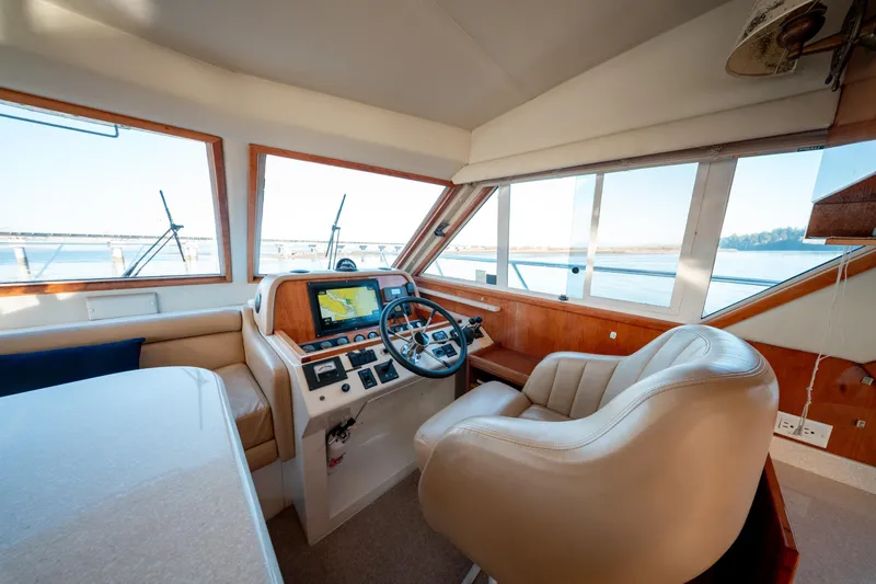  Yacht Photos Pics Luxurious 2003 Navigator 3900 yacht interior with helm, leather seat, and navigation system.