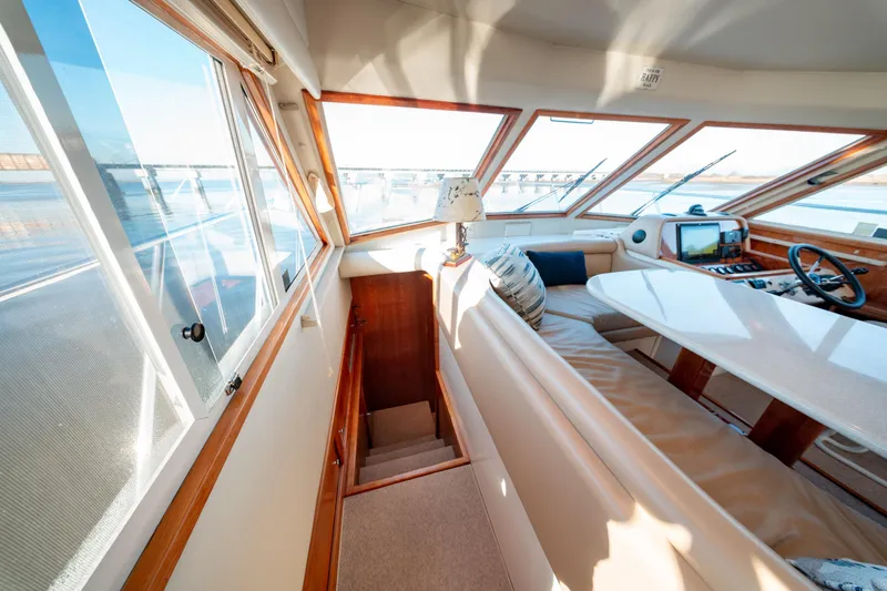  Yacht Photos Pics Luxurious interior of 2003 Navigator 3900 yacht with panoramic windows and plush seating.