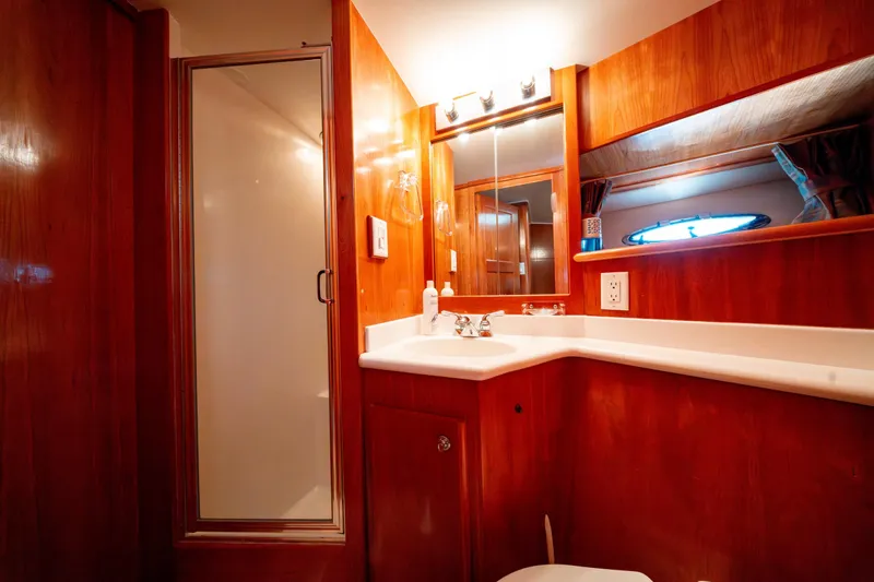  Yacht Photos Pics Luxurious 2003 Navigator 3900 yacht bathroom with wood accents and modern fixtures.