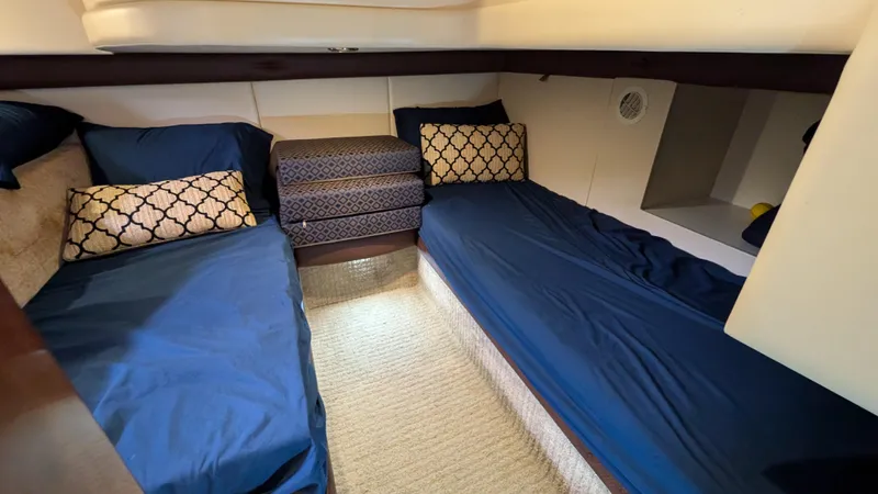  Yacht Photos Pics 2008 Meridian 341 Sedan cabin with twin beds, blue bedding, and decorative pillows.