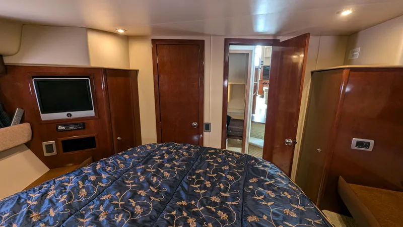  Yacht Photos Pics Interior of 2008 Meridian 341 Sedan yacht bedroom with TV and wooden cabinetry.