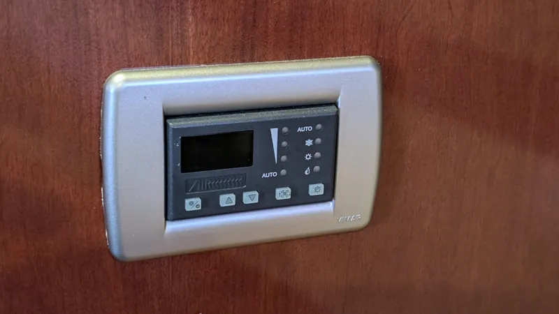  Yacht Photos Pics Control panel on 2008 Meridian 341 Sedan yacht interior, mounted on wooden surface.