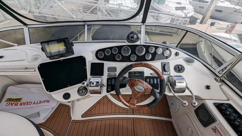  Yacht Photos Pics 2008 Meridian 341 Sedan helm with wood accents and modern navigation equipment.