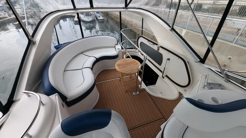  Yacht Photos Pics 2008 Meridian 341 Sedan yacht interior with white seating and wooden table, docked at marina.