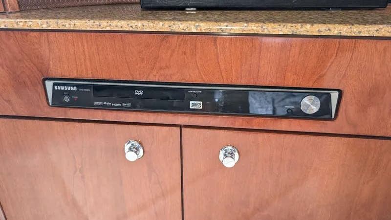  Yacht Photos Pics DVD player in 2008 Meridian 341 Sedan yacht interior, mounted on wooden cabinet.