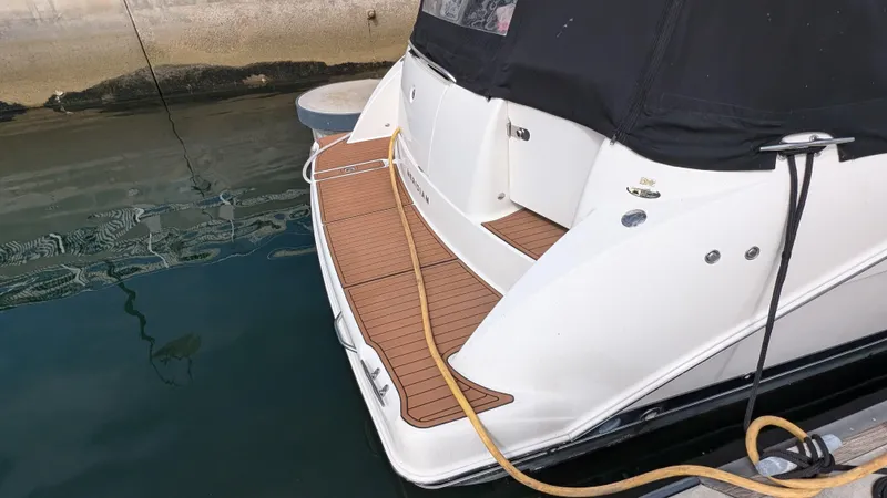  Yacht Photos Pics 2008 Meridian 341 Sedan boat docked, featuring a wooden deck and black canopy.