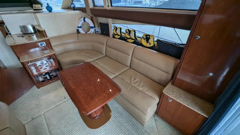  Yacht Photos Pics 2008 Meridian 341 Sedan interior with beige leather seating and wooden table.