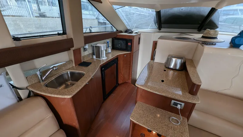  Yacht Photos Pics Interior of 2008 Meridian 341 Sedan yacht with kitchenette and seating area.