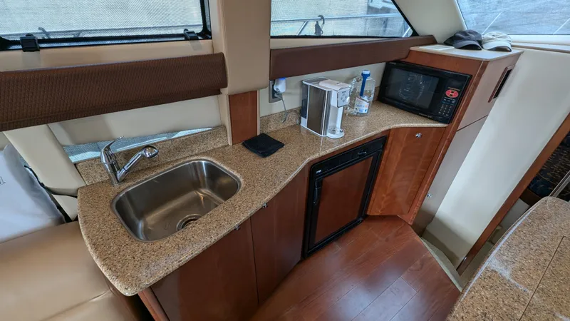  Yacht Photos Pics 2008 Meridian 341 Sedan yacht kitchen with sink, microwave, and countertop appliances.