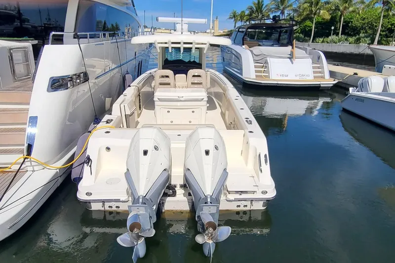 Timber Yacht Photos Pics 2023 Boston Whaler 330 Outrage docked, featuring dual outboard engines.