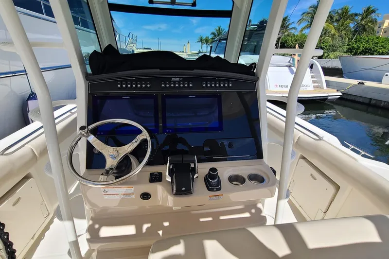 Timber Yacht Photos Pics 2023 Boston Whaler 330 Outrage helm with dual screens and steering wheel.