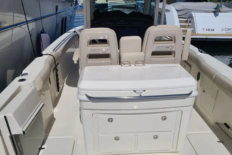 Timber Yacht Photos Pics 2023 Boston Whaler 330 Outrage boat interior with seating and storage compartments.