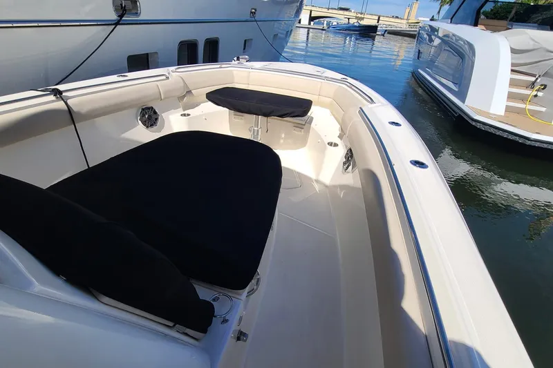 Timber Yacht Photos Pics 2023 Boston Whaler 330 Outrage boat interior with seating, docked in marina.