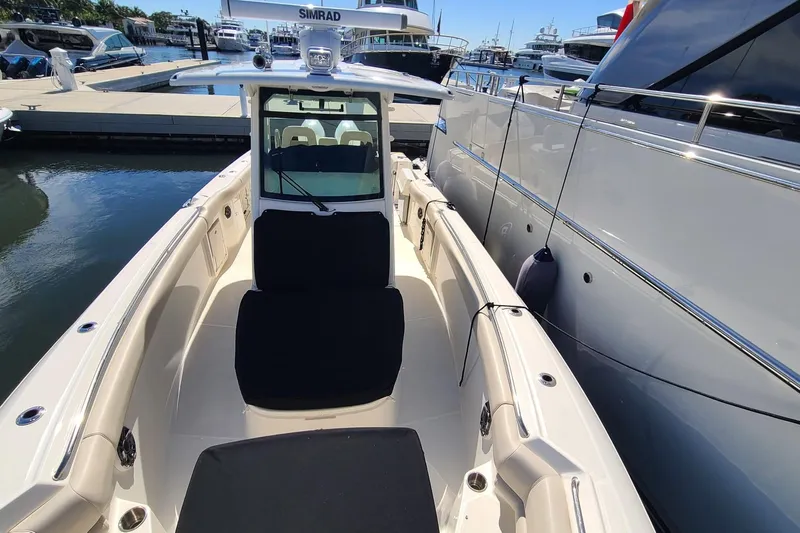 Timber Yacht Photos Pics 2023 Boston Whaler 330 Outrage docked at marina, showcasing sleek design and spacious deck.