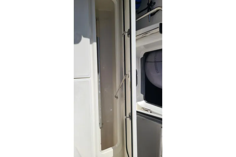 Timber Yacht Photos Pics 2023 Boston Whaler 330 Outrage interior storage compartment with visible equipment.