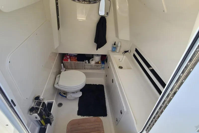 Timber Yacht Photos Pics Interior of 2023 Boston Whaler 330 Outrage boat bathroom with toilet and sink.