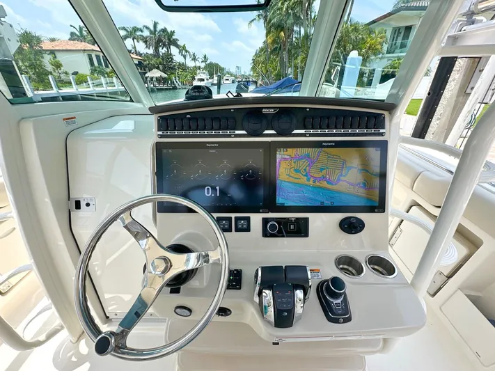  Yacht Photos Pics Boston Whaler 380 Outrage 2021 helm with dual displays and steering wheel.