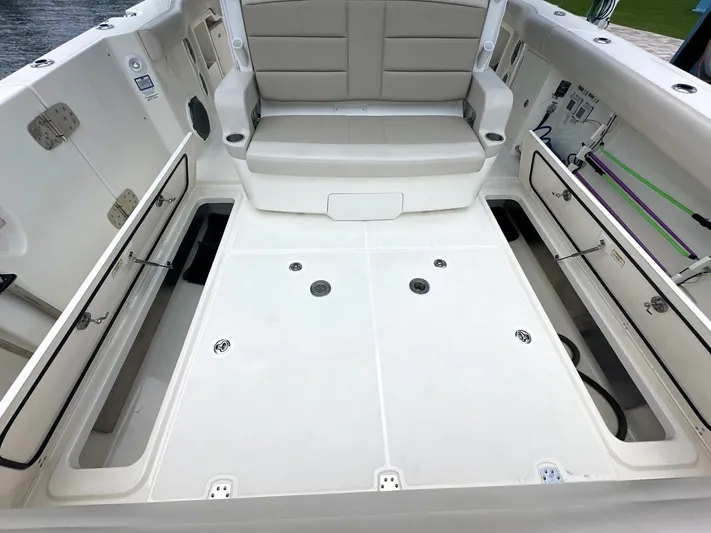  Yacht Photos Pics 2021 Boston Whaler 380 Outrage boat interior with spacious seating and storage compartments.
