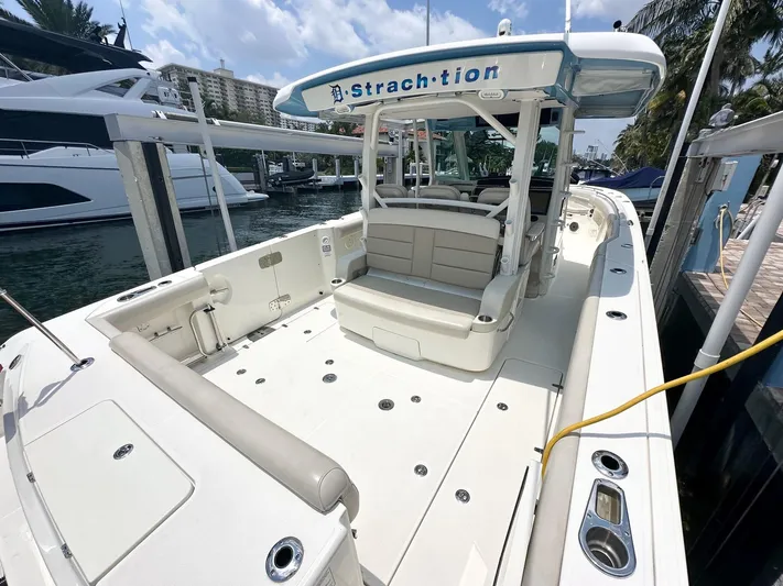  Yacht Photos Pics 2021 Boston Whaler 380 Outrage boat docked, featuring spacious deck and seating area.