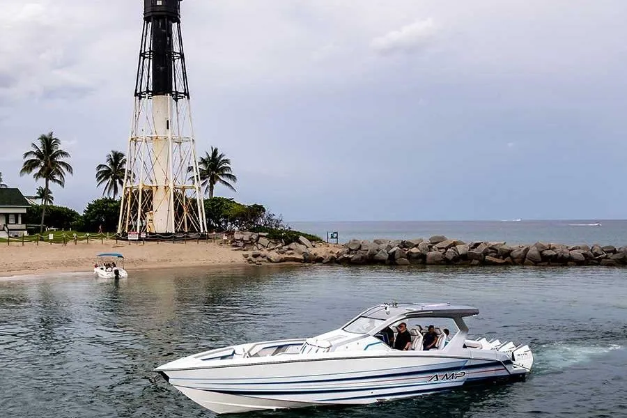 2026 American Marine Performance AMP 433 boat near a lighthouse and palm trees.
