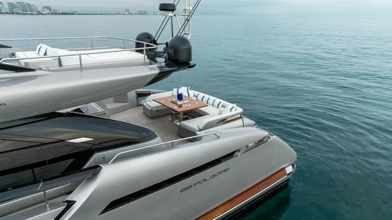 Our Trade Yacht Photos Pics Luxury 2021 Riva 88' FOLGORE yacht on calm waters with elegant deck seating.