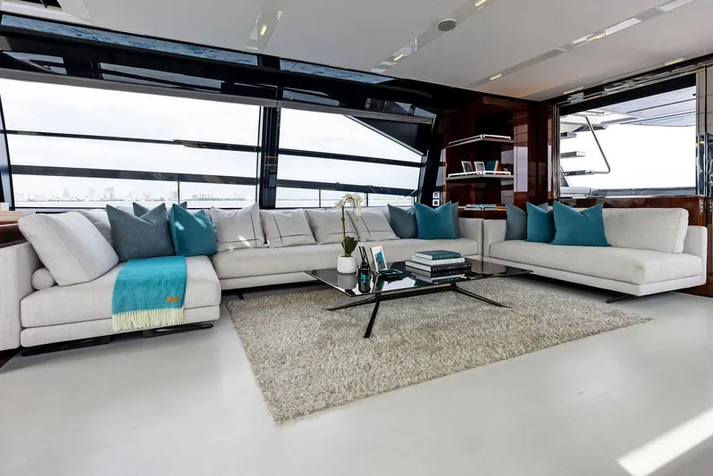 Our Trade Yacht Photos Pics Luxurious interior of 2021 Riva 88' FOLGORE yacht with modern white sofas and large windows.