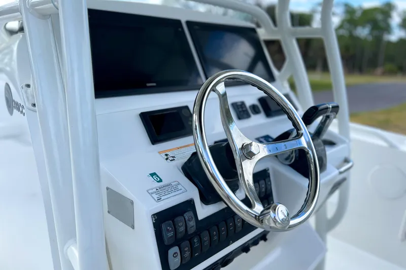  Yacht Photos Pics Steering console of 2011 Edgewater 318CC boat with modern controls and displays.