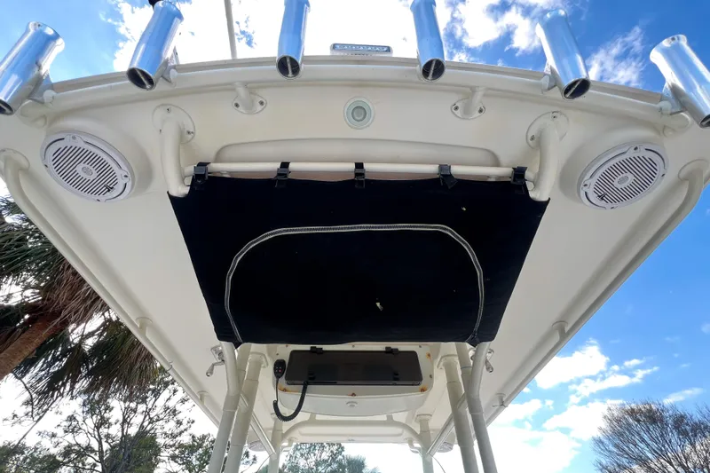  Yacht Photos Pics 2011 Edgewater 318CC boat canopy with speakers and rod holders under a blue sky.