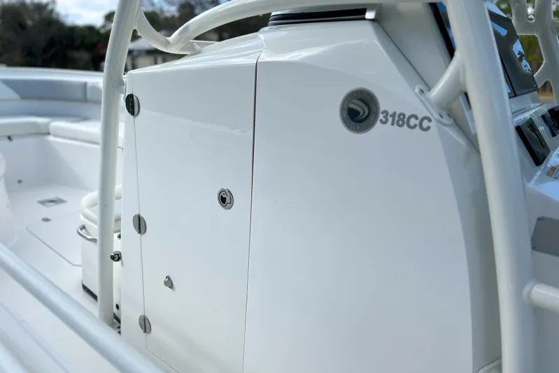  Yacht Photos Pics 2011 Edgewater 318CC boat console with sleek white design and secure storage.