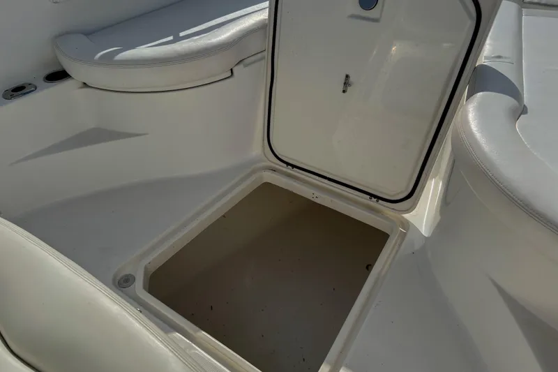  Yacht Photos Pics Open storage compartment on 2011 Edgewater 318CC boat, featuring white cushioned seating.