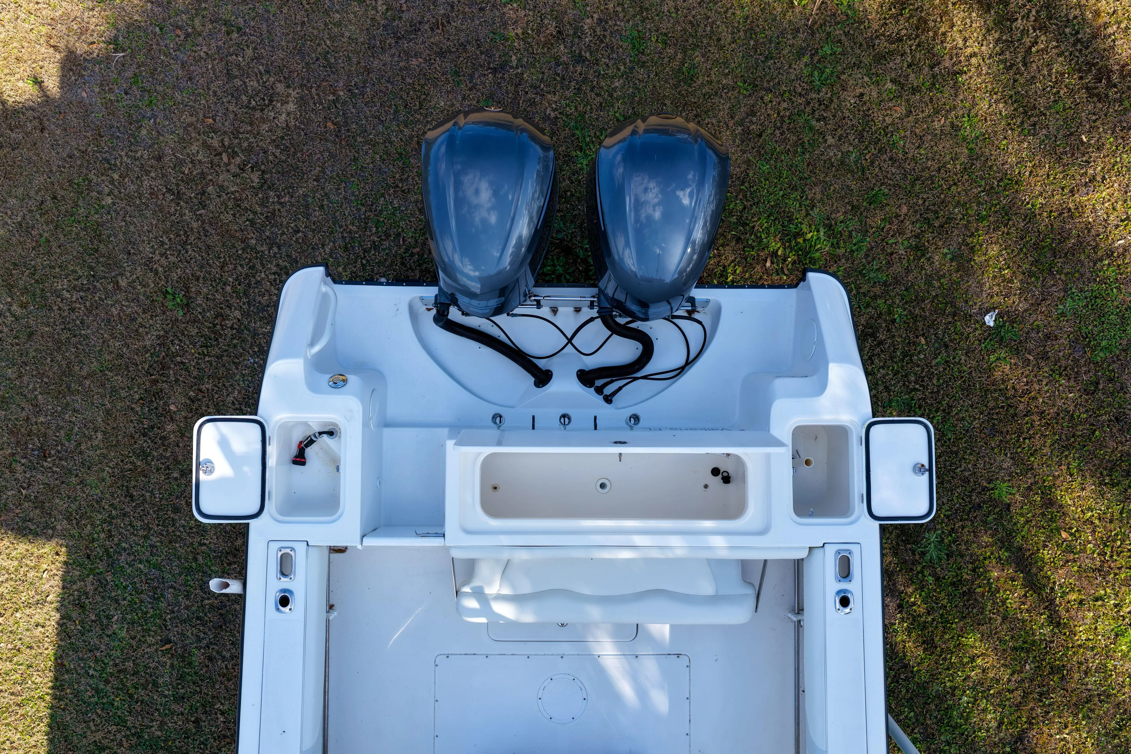  Yacht Photos Pics Overhead view of 2011 Edgewater 318CC boat with dual engines on grass.