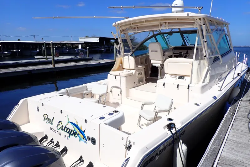  Yacht Photos Pics 2015 Grady-White Express 370 boat docked, featuring spacious deck and seating.