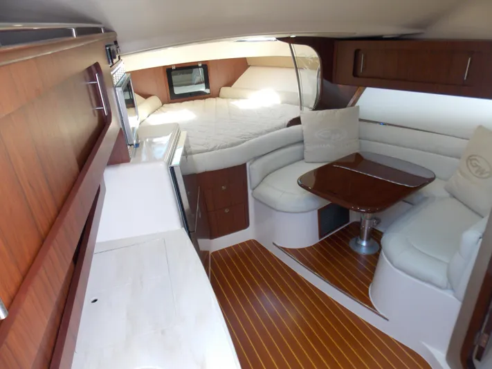  Yacht Photos Pics Luxurious interior of 2015 Grady-White Express 370 boat with cozy seating and wood finishes.